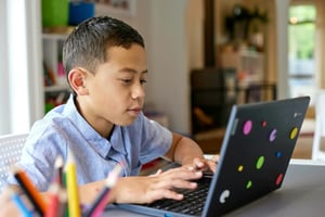 Student home learning at laptop